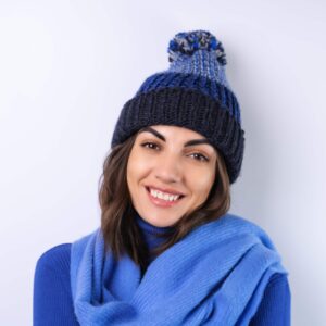 young-woman-blue-golf-turtleneck-hat-scarf-white-background-cheery-good-mood